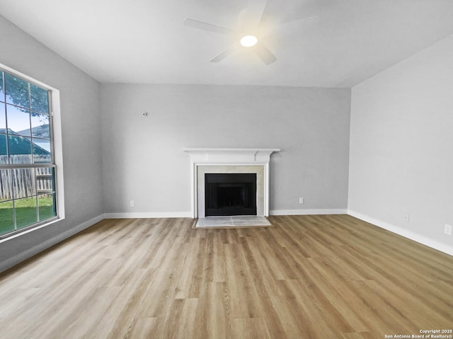 334 Sunrose, Cibolo, TX 78108 - unfurnished living room with ceiling fan, light wood-style floors, a fireplace with flush hearth, and baseboards