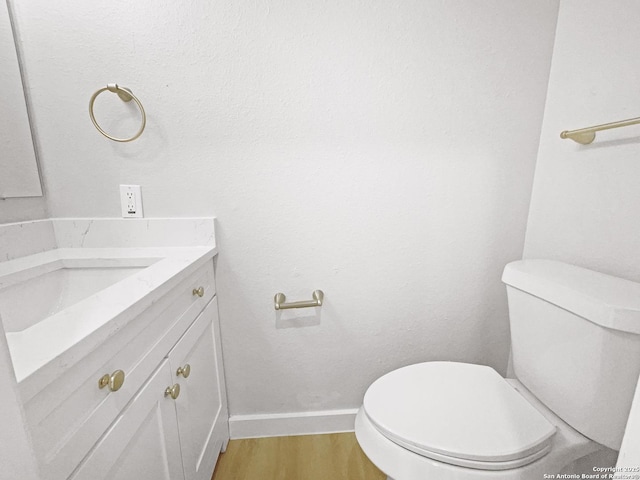 334 Sunrose, Cibolo, TX 78108 - half bathroom featuring vanity, toilet, wood finished floors, and baseboards