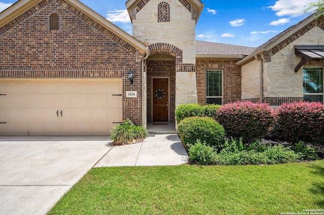 1036 Carriage, New Braunfels, TX 78132 - french country home featuring stone siding, brick siding, concrete driveway, a garage, and a shingled roof