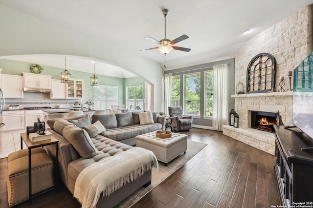 1036 Carriage, New Braunfels, TX 78132 - living room featuring arched walkways, ceiling fan, dark wood-style flooring, and a fireplace
