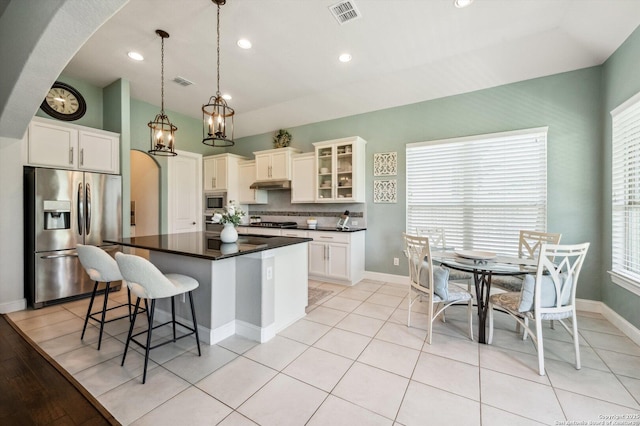 1036 Carriage, New Braunfels, TX 78132 - kitchen with stainless steel appliances, dark countertops, arched walkways, healthy amount of natural light, and vaulted ceiling