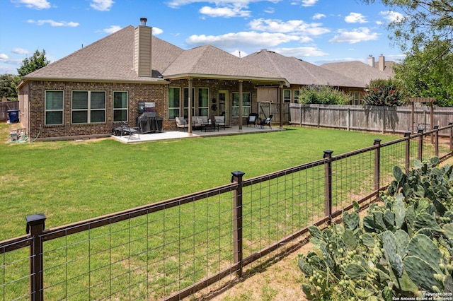 1036 Carriage, New Braunfels, TX 78132 - back of house with brick siding, a chimney, a patio area, and a shingled roof