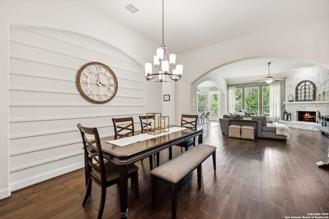 1036 Carriage, New Braunfels, TX 78132 - dining area with arched walkways, dark wood-style floors, a stone fireplace, and a ceiling fan