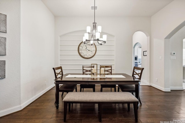 1036 Carriage, New Braunfels, TX 78132 - dining space with arched walkways, a chandelier, dark wood finished floors, and baseboards