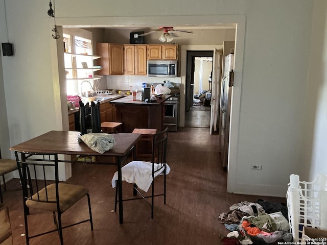 1273 Crk 180, Smiley, TX 78159 - kitchen featuring appliances with stainless steel finishes, decorative backsplash, ceiling fan, open shelves, and light brown cabinetry