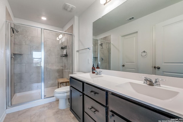 11745 Red Pheasant, San Antonio, TX 78245 - bathroom featuring toilet, double vanity, a shower stall, and tile patterned floors