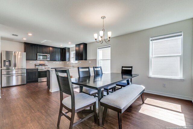 11745 Red Pheasant, San Antonio, TX 78245 - dining space with a chandelier, dark wood finished floors, baseboards, and recessed lighting