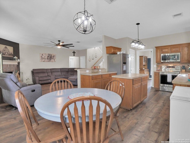 1775 Jasons N, New Braunfels, TX 78130 - dining room with a chandelier, ceiling fan, dark wood-type flooring, and a fireplace