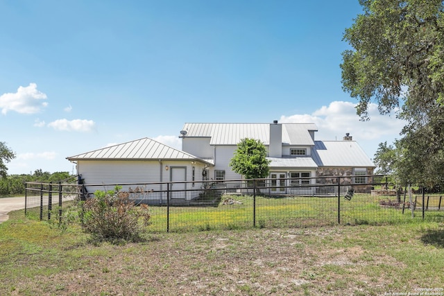 269 Red Rose, Spring Branch, TX 78070 - rear view of house featuring a standing seam roof, a chimney, and a metal roof