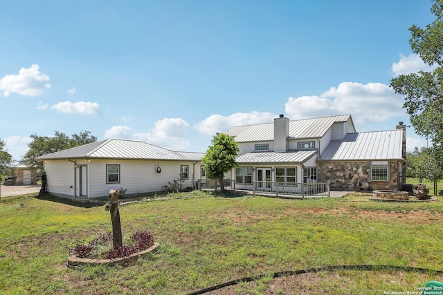 269 Red Rose, Spring Branch, TX 78070 - back of house featuring a chimney, a fire pit, and a yard