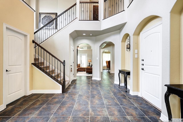 8126 Powderhorn Run, San Antonio, TX 78255 - entryway with baseboards, stairs, and arched walkways