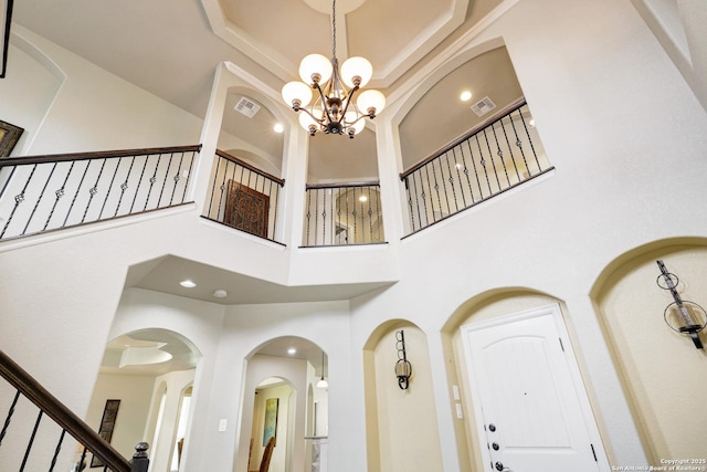 8126 Powderhorn Run, San Antonio, TX 78255 - entrance foyer with a high ceiling, stairway, a chandelier, and arched walkways