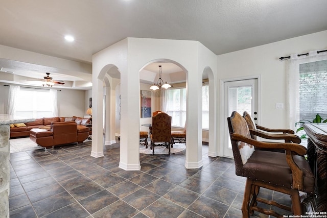 8126 Powderhorn Run, San Antonio, TX 78255 - living room featuring baseboards, arched walkways, a chandelier, and a ceiling fan