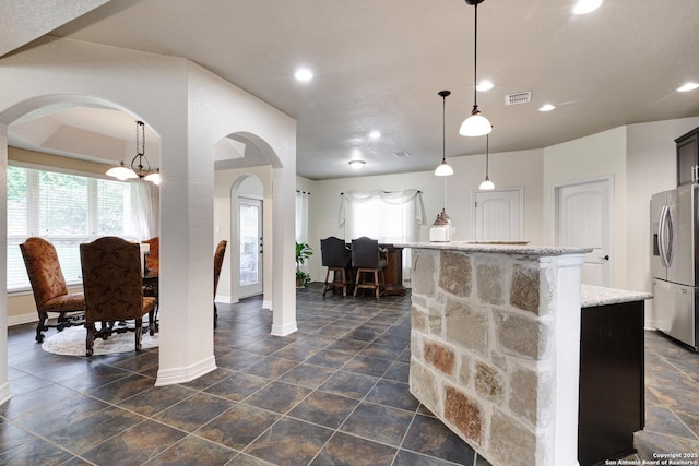 8126 Powderhorn Run, San Antonio, TX 78255 - kitchen featuring stainless steel fridge, arched walkways, baseboards, plenty of natural light, and recessed lighting