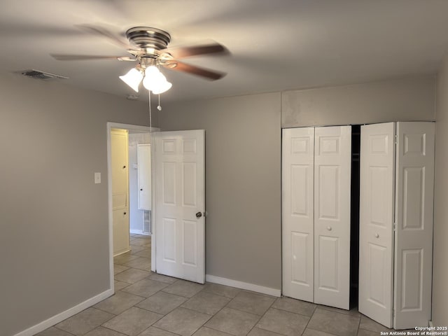 1715 Parnell, San Antonio, TX 78224 - unfurnished bedroom with light tile patterned flooring, baseboards, a closet, and ceiling fan