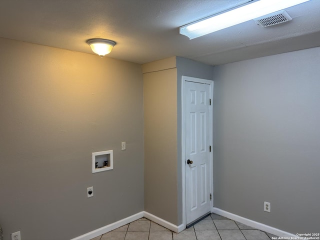 1715 Parnell, San Antonio, TX 78224 - laundry room with electric dryer hookup, washer hookup, light tile patterned floors, and baseboards