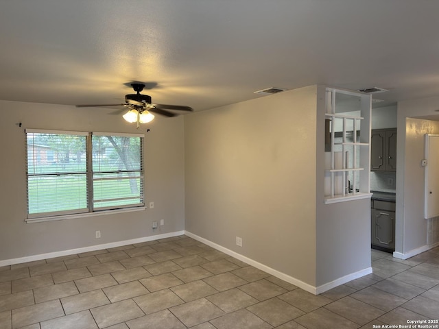 1715 Parnell, San Antonio, TX 78224 - unfurnished room with a ceiling fan, light tile patterned floors, and baseboards