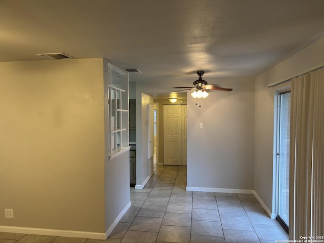 1715 Parnell, San Antonio, TX 78224 - spare room with a ceiling fan, light tile patterned floors, and baseboards