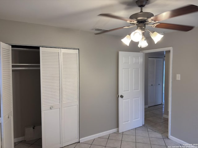 1715 Parnell, San Antonio, TX 78224 - unfurnished bedroom with a closet, light tile patterned floors, baseboards, and a ceiling fan