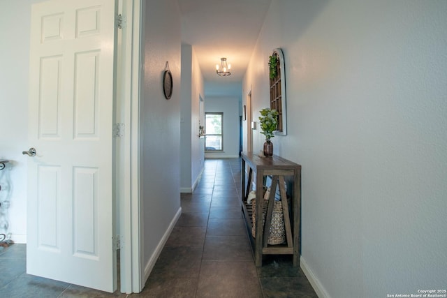 3606 Mill Mdw, San Antonio, TX 78247 - hallway with dark tile patterned floors, baseboards, and a chandelier