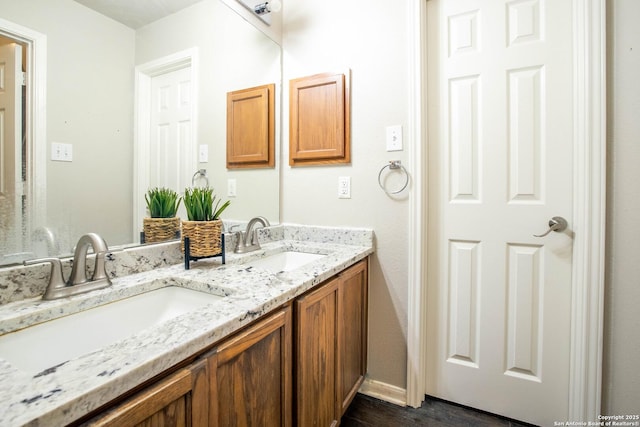 3606 Mill Mdw, San Antonio, TX 78247 - bathroom featuring double vanity, wood finished floors, and baseboards