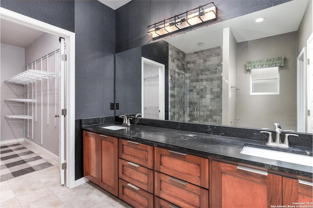 9527 Butterfly Bnd, San Antonio, TX 78224 - bathroom featuring a stall shower, double vanity, and baseboards
