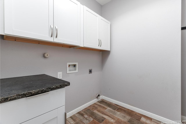 9527 Butterfly Bnd, San Antonio, TX 78224 - laundry area with cabinet space, electric dryer hookup, wood finished floors, hookup for a washing machine, and baseboards