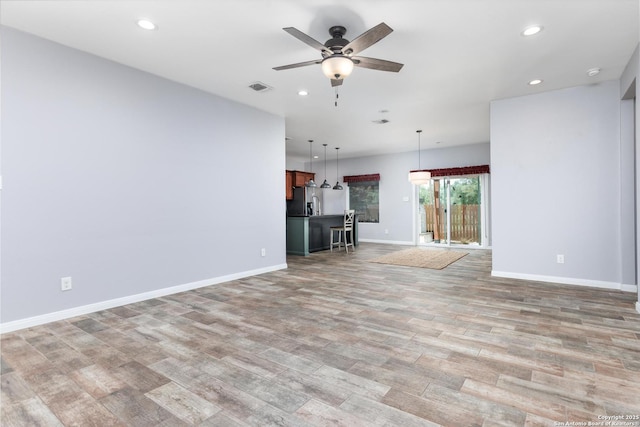 9527 Butterfly Bnd, San Antonio, TX 78224 - unfurnished living room with light wood-type flooring, ceiling fan, recessed lighting, and baseboards