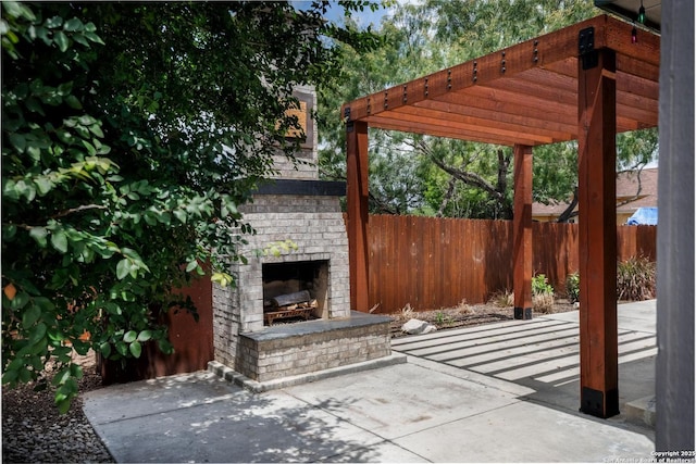 9527 Butterfly Bnd, San Antonio, TX 78224 - view of patio featuring an outdoor brick fireplace