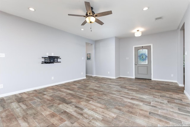 9527 Butterfly Bnd, San Antonio, TX 78224 - unfurnished living room featuring a ceiling fan, recessed lighting, wood finished floors, and baseboards