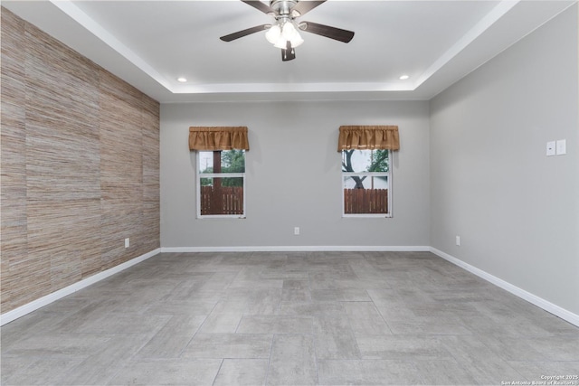 9527 Butterfly Bnd, San Antonio, TX 78224 - unfurnished room featuring a ceiling fan, plenty of natural light, a raised ceiling, baseboards, and recessed lighting