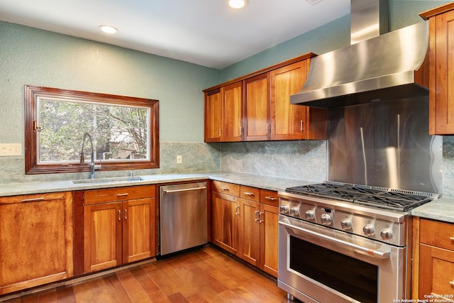 13810 S Port Blf, San Antonio, TX 78216 - kitchen featuring appliances with stainless steel finishes, wall chimney exhaust hood, brown cabinets, and recessed lighting