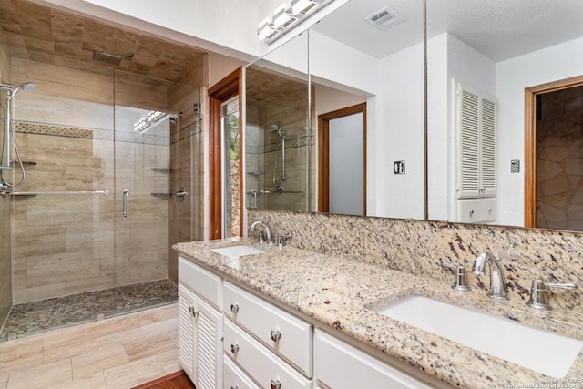 13810 S Port Blf, San Antonio, TX 78216 - bathroom featuring a stall shower, double vanity, and backsplash