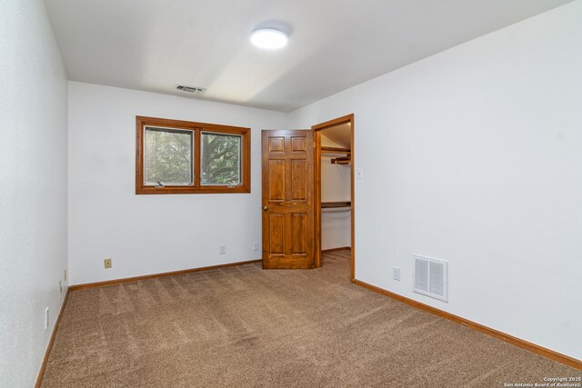 13810 S Port Blf, San Antonio, TX 78216 - unfurnished bedroom featuring carpet, baseboards, a spacious closet, and a closet