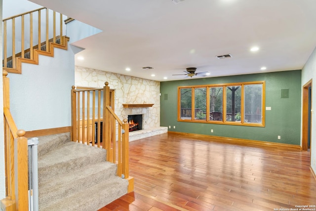 13810 S Port Blf, San Antonio, TX 78216 - unfurnished living room featuring stairs, ceiling fan, hardwood / wood-style flooring, recessed lighting, and a stone fireplace