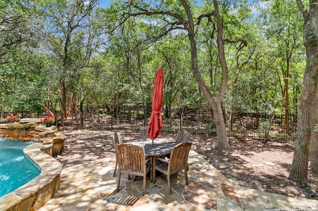 13810 S Port Blf, San Antonio, TX 78216 - view of patio / terrace featuring an outdoor pool, outdoor dining area, and view of scattered trees