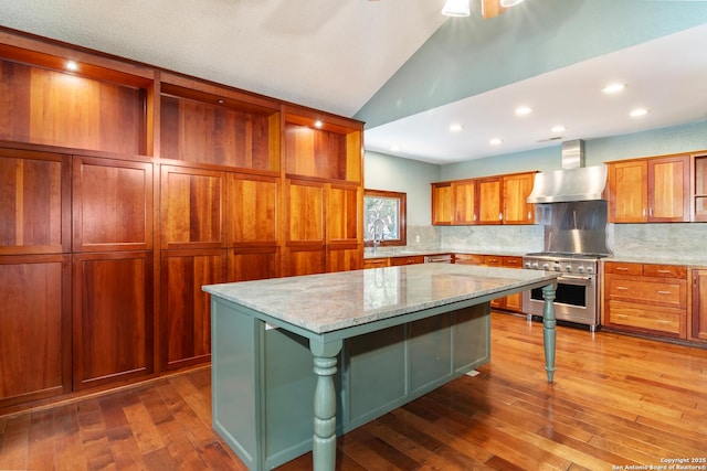 13810 S Port Blf, San Antonio, TX 78216 - kitchen with high end range, wall chimney exhaust hood, vaulted ceiling, dark wood-type flooring, and a center island