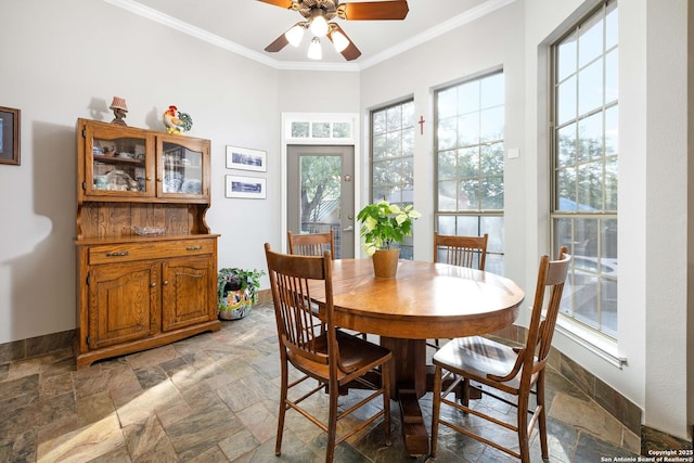 278 Stonebrook, New Braunfels, TX 78132 - dining space with stone tile floors, crown molding, ceiling fan, and baseboards