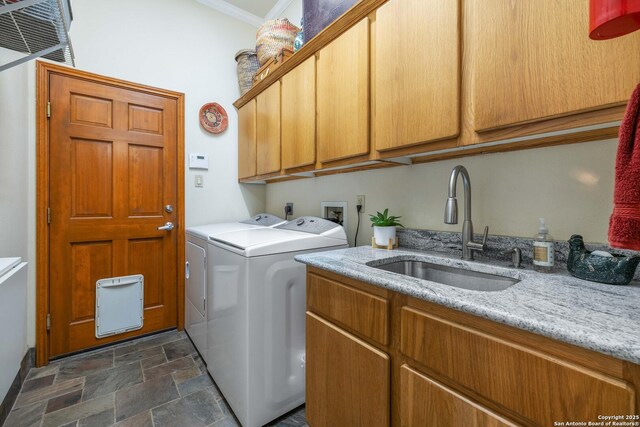278 Stonebrook, New Braunfels, TX 78132 - washroom featuring stone finish floors, cabinet space, washer and dryer, and ornamental molding