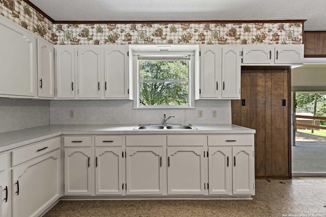 1706 Hickory St, Floresville, TX 78114 - kitchen with white cabinets, a textured ceiling, and light countertops