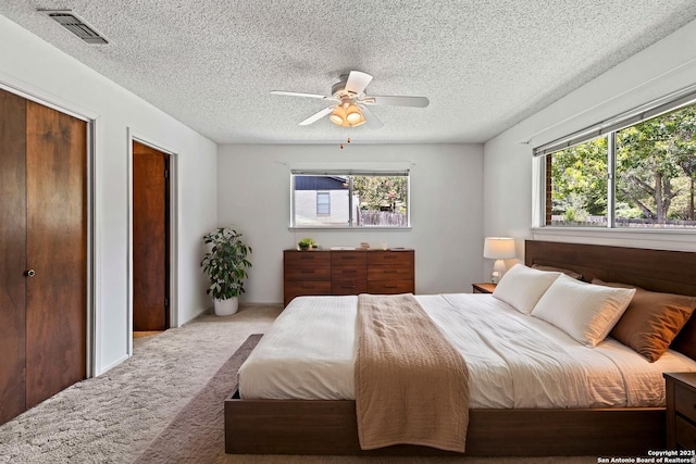 1706 Hickory St, Floresville, TX 78114 - carpeted bedroom with a textured ceiling and ceiling fan