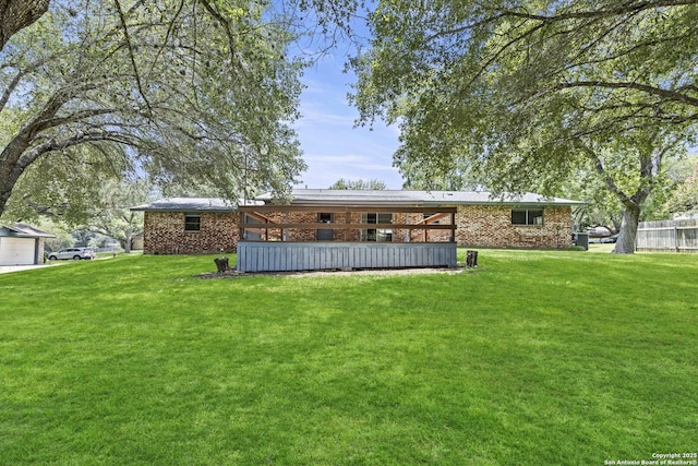 1706 Hickory St, Floresville, TX 78114 - back of house with a yard and brick siding