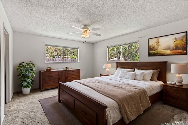 1706 Hickory St, Floresville, TX 78114 - bedroom with multiple windows, light colored carpet, a textured ceiling, and a ceiling fan