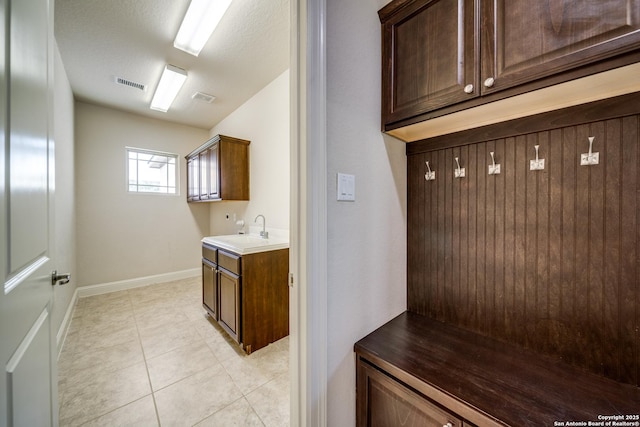 1703 Slumber Pass, San Antonio, TX 78260 - mudroom with a sink, light tile patterned floors, and baseboards