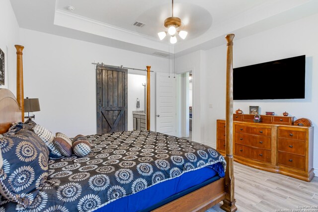 34784 High Gate, Bulverde, TX 78163 - bedroom featuring light wood-type flooring, a raised ceiling, ornamental molding, connected bathroom, and a ceiling fan