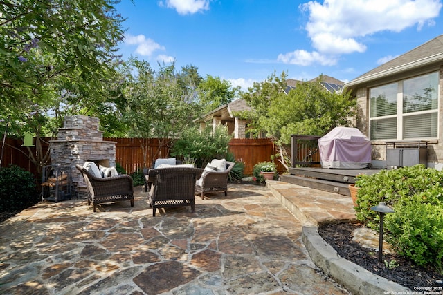 28915 Porch Swing, Boerne, TX 78006 - fenced backyard with grilling area, a patio, and an outdoor living space with a fireplace