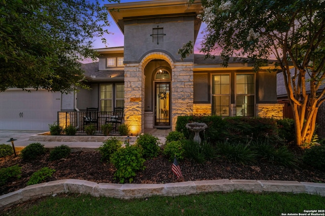 28915 Porch Swing, Boerne, TX 78006 - view of front facade featuring stone siding, concrete driveway, and an attached garage