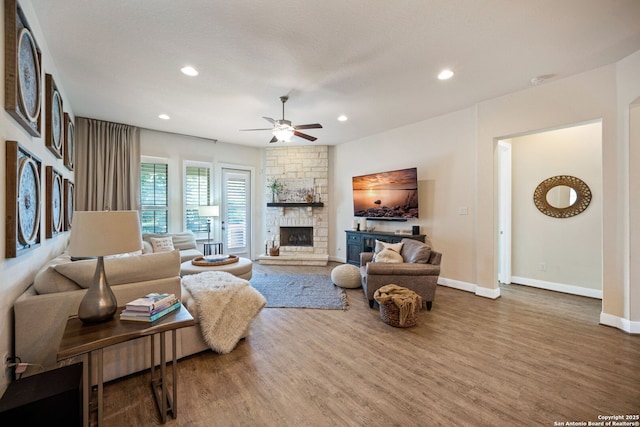 28915 Porch Swing, Boerne, TX 78006 - living room featuring wood finished floors, ceiling fan, a stone fireplace, recessed lighting, and baseboards