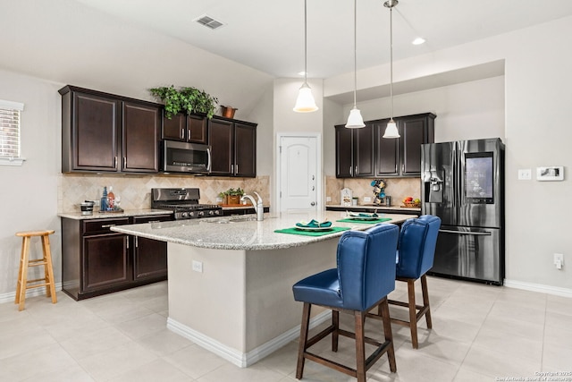27510 Smokey Chase, Boerne, TX 78015 - kitchen featuring fridge with ice dispenser, stainless steel microwave, stove, decorative backsplash, and a breakfast bar