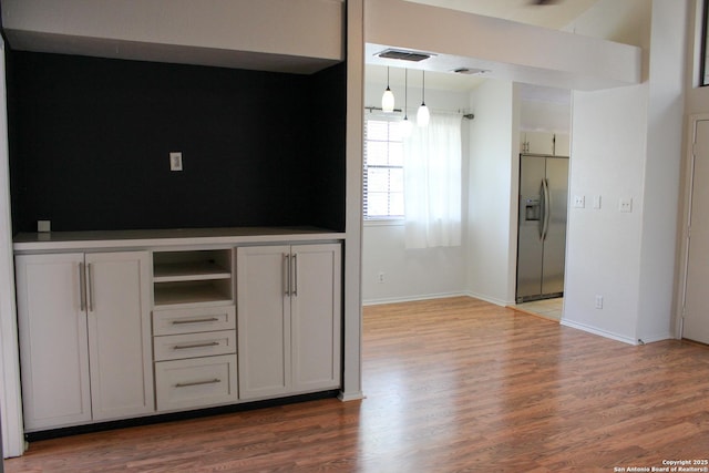 11815 Vance Jackson Unit 301, San Antonio, TX 78230 - kitchen with stainless steel fridge, wood finished floors, baseboards, and open shelves